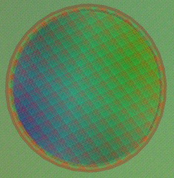 An abstract digital artwork featuring a circular sphere rendered in green, blue, and red tones on a textured green background, resembling a planet or globe.