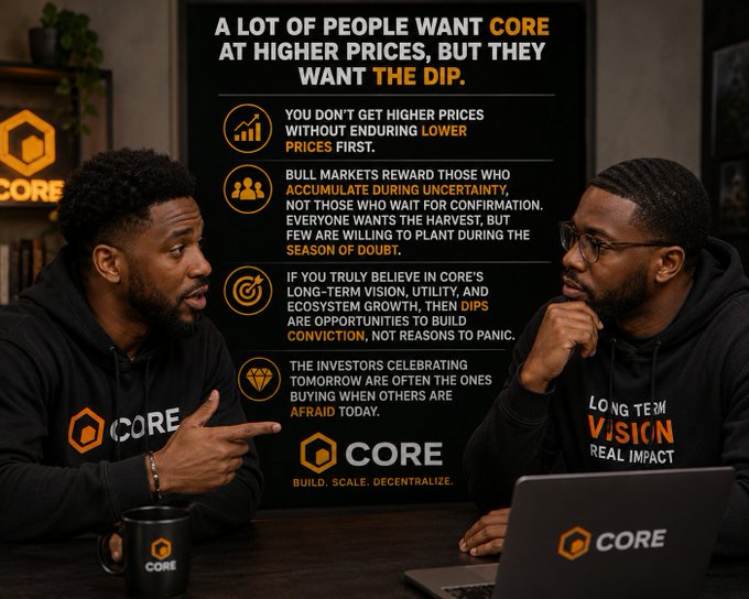 "The two men sitting at the table are talking about investing, with one of them having a laptop open in front of him that has the Core logo displayed. The conversation seems to be centered around the value of the Core brand or investment opportunities, possibly discussing a stock or fund within the Core platform."
