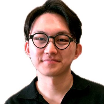 A close-up portrait of a young East Asian man with dark-rimmed glasses, smiling slightly against a plain white background.