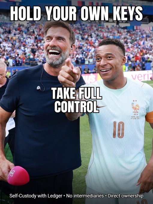 A crypto advertisement featuring soccer figures Jurgen Klopp and Kylian Mbappé with the text 'HOLD YOUR OWN KEYS' and 'TAKE FULL CONTROL', promoting 'Self-Custody with Ledger • No intermediaries • Direct ownership' at the bottom.