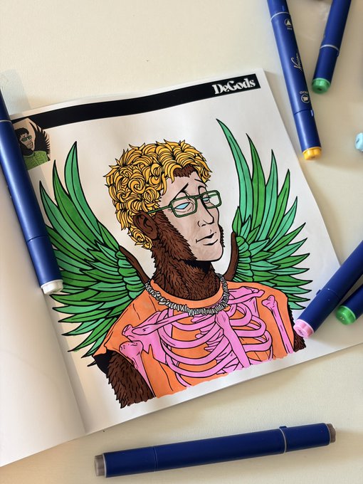 A partially colored illustration in a 'DeGods' art book depicts a figure with curly blonde hair, glasses, green wings, and a pink skeletal chest, surrounded by blue markers.