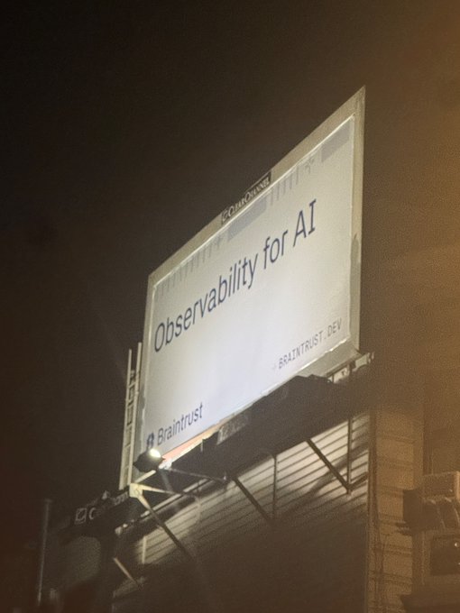 A nighttime billboard advertises "Observability for AI" by Braintrust.dev, mocking the vague, AI-buzzword-laden marketing approach criticized in the post.