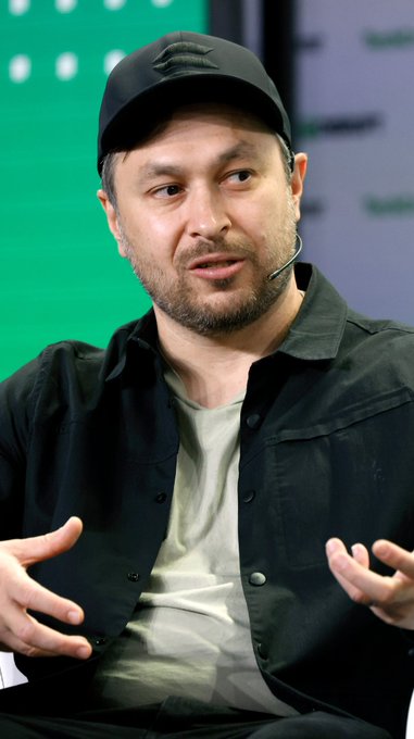 A man in a black cap and shirt speaks with an animated expression, gesturing with both hands while wearing a microphone headset, appearing to engage in a passionate discussion or debate.

The image complements the post by visually capturing the speaker's emphatic stance, mirroring the confrontational tone of the text criticizing dismissiveness in arguments about Robinhood and advocating for substantive, technical rebuttals.