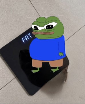 A photo of a small digital screen displaying an AI-generated Pepe the Frog character wearing a blue shirt with 'FAT' written in neon-style text.