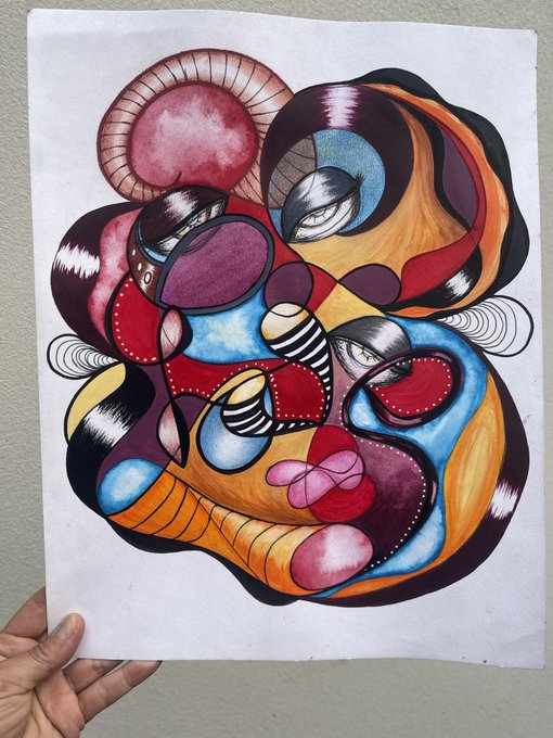 A hand holds up an abstract painting featuring swirling organic shapes in red, blue, purple, orange, and black with stylized eyes and striped patterns.