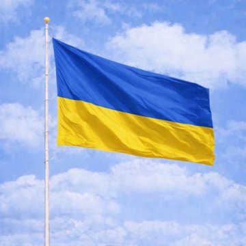 The Ukrainian flag waves against a partly cloudy sky, symbolizing Ukraine's recent transfer of $8.3 million in seized USDT into state management as the country explores establishing a national crypto reserve.