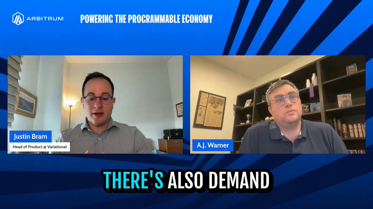 The image shows two men sitting behind a desk, having a conversation about the current state of the economy. The background features a blue and white striped pattern that matches the color scheme of the post discussing the power of programming for the economy. The text in the image reads "There's also demand" which is related to the post's content on Arbitrum.