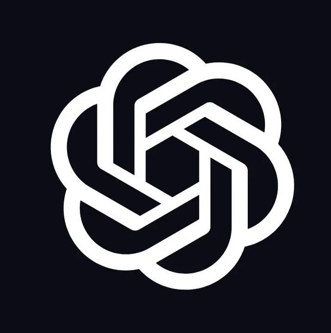 The image is a white, stylized logo composed of interlocking geometric shapes that resemble a flower or knot, set against a dark navy background. It appears to be the OpenAI logo, relating to the news that the FTC is investigating the company over potential consumer deception regarding AI safety practices.
