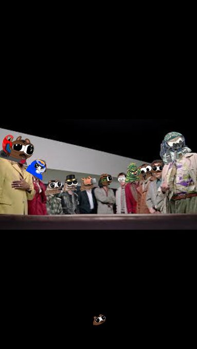 A group of people wearing paper bags or cardboard masks over their faces stand in a line on what appears to be a stage, with one small masked figure visible separately in the lower portion of the dark image.