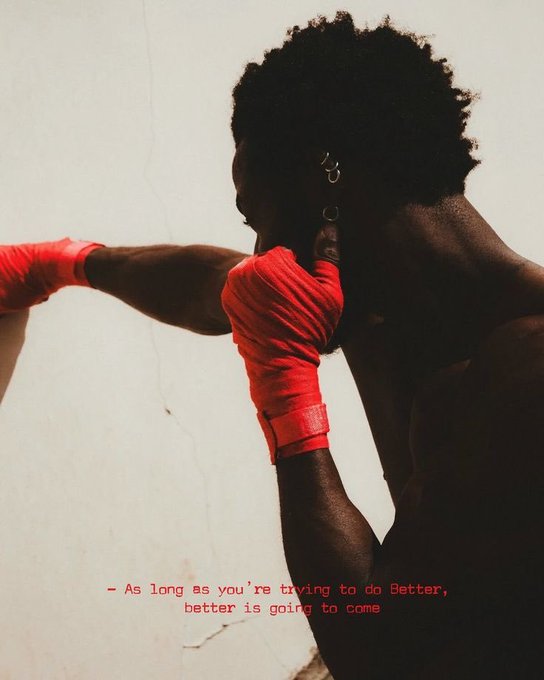 A stylized photo of a Black boxer with red hand wraps training, overlaid with the motivational text: '- As long as you're trying to do better, better is going to come'.