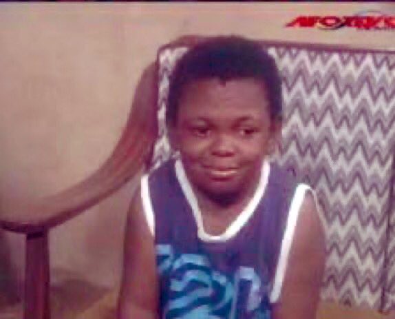 A child sits in front of a patterned couch with an "APORTS" logo visible in the upper right corner, smiling slightly at the camera. The image illustrates the post's point about how free NFT mints exploit people's innocence and eagerness for "free" gains—much like a child's trusting smile—luring unsuspecting users into connecting their wallets to malicious sites.