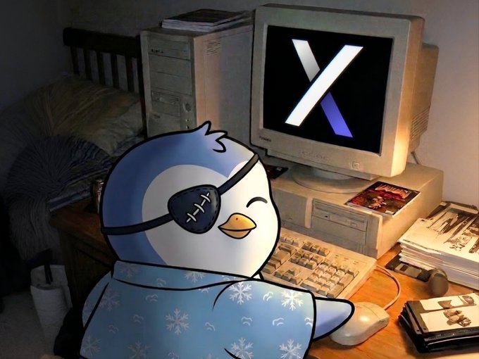 The image features a cartoon penguin sitting at a desk using a computer mouse while wearing a blue scarf. The background shows a desktop computer monitor displaying an X logo. There are also books visible in the scene, suggesting that this might be a workspace or study area for someone who uses the computer regularly.