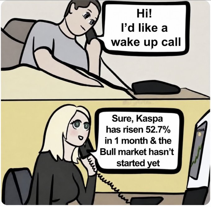 A two-panel comic strip meme where a man asks for a wake-up call, and a blonde woman replies, 'Sure, Kaspa has risen 52.7% in 1 month & the Bull market hasn't started yet' while looking at a green chart.