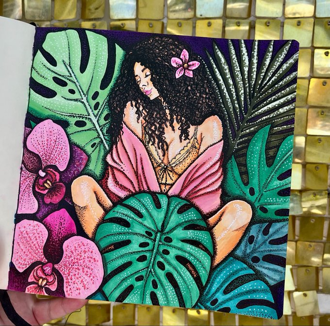 A vibrant illustration in a sketchbook shows a woman surrounded by tropical leaves and pink orchids against a sequined background.