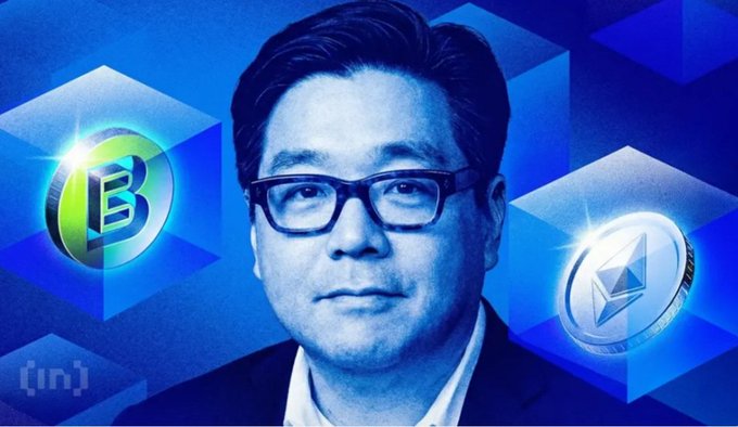A portrait of Tom Lee, founder of Fundstrat, wearing glasses and a suit, shown against a blue geometric background with Bitcoin and Ethereum coin graphics on either side.