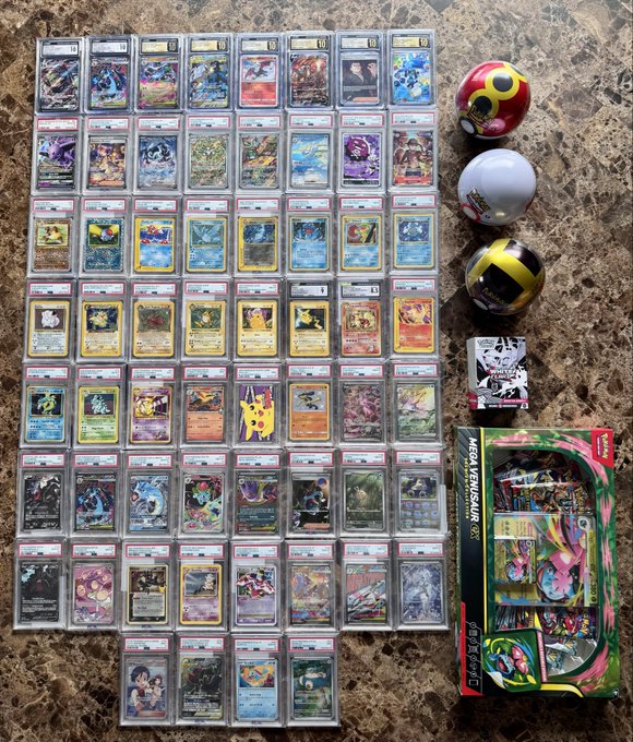 A large collection of graded Pokémon cards in PSA slabs arranged on a marble floor, accompanied by three Pokéball replicas and a Mega Venusaur EX special box set.