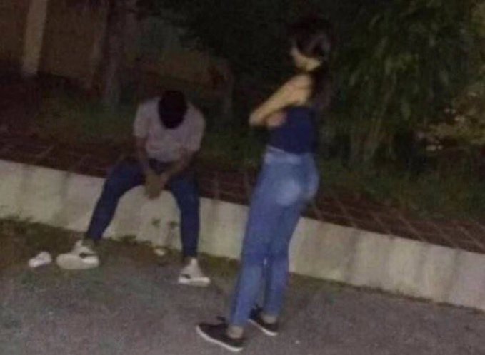 A man sits slumped on a curb with his head down in apparent despair, while a woman stands over him with arms crossed in an annoyed posture, humorously symbolizing the disappointment of crypto/memecoin losses referenced in the caption.