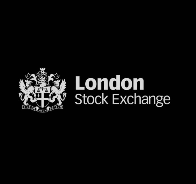The image displays the London Stock Exchange logo, featuring its heraldic crest with the Latin motto "Dictum Meum Pactum" alongside white text on a black background. The logo directly represents the institution mentioned in the post as it prepares to adopt 24/7 trading in response to competition from cryptocurrency markets.