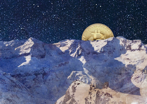 A large golden Bitcoin coin rests atop snow-covered mountain peaks beneath a starry night sky.