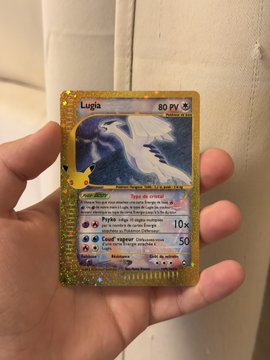 A hand holds up a shiny gold "Lugia" Pokémon card (80 HP) from the 30th anniversary set, showcasing a rare holographic pull that appears to confirm the poster's prediction about high-value cards being obtainable in the new set.