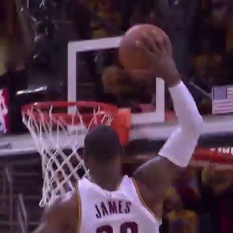 An action shot of basketball player LeBron James (jersey #23) going up for a dunk near the rim during a game.