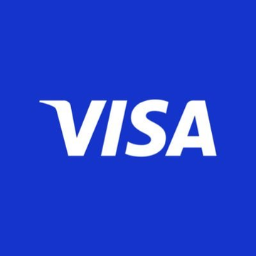 The image displays the Visa logo, featuring the brand name "VISA" in white text on a blue background, representing the company's role in the stablecoin merchant prefunding and payout partnership with Zero Hash to enhance cross-border transactions.