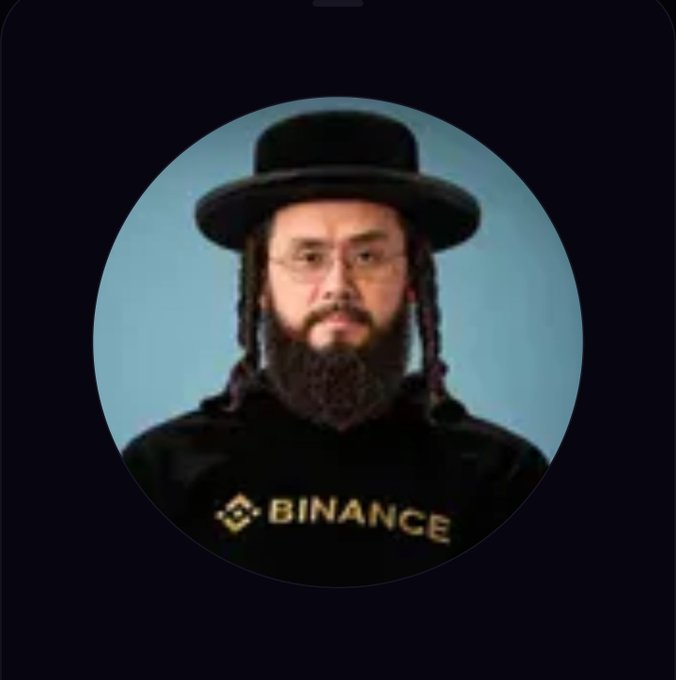 A circular profile image shows a man with a beard, glasses, and a black hat with sidelocks, wearing a black shirt that displays the gold 'BINANCE' logo and text.