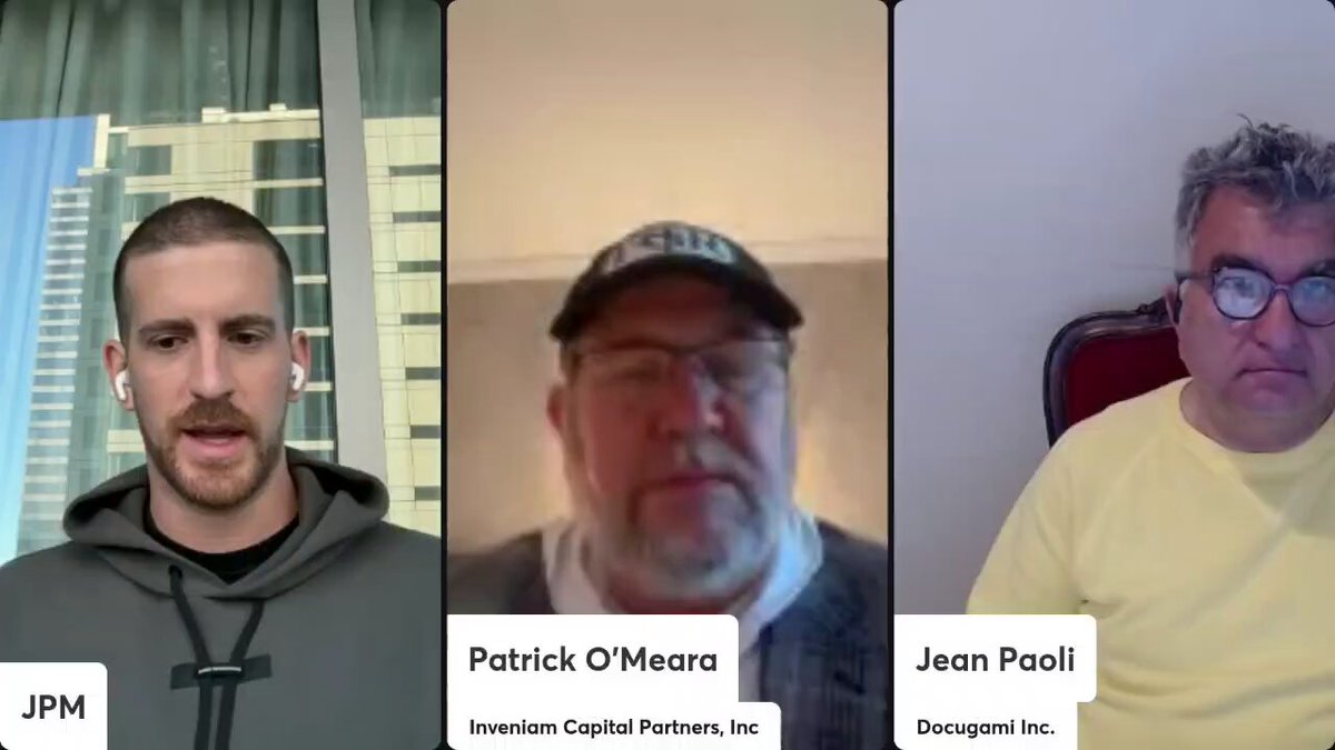 The image shows three men sitting down for a video call with their names displayed at the bottom of the screen. They are all wearing glasses and hats, suggesting that they might be professionals or involved in an intellectual discussion. The caption below the image reads "The @InveniamIO acquisition of @MANTRA Chain doesn't change the mission. It just adds more builders, more resources, and even more momentum behind $MANTRA". This message emphasizes the importance of their conversation and how it aligns with the company's goals.