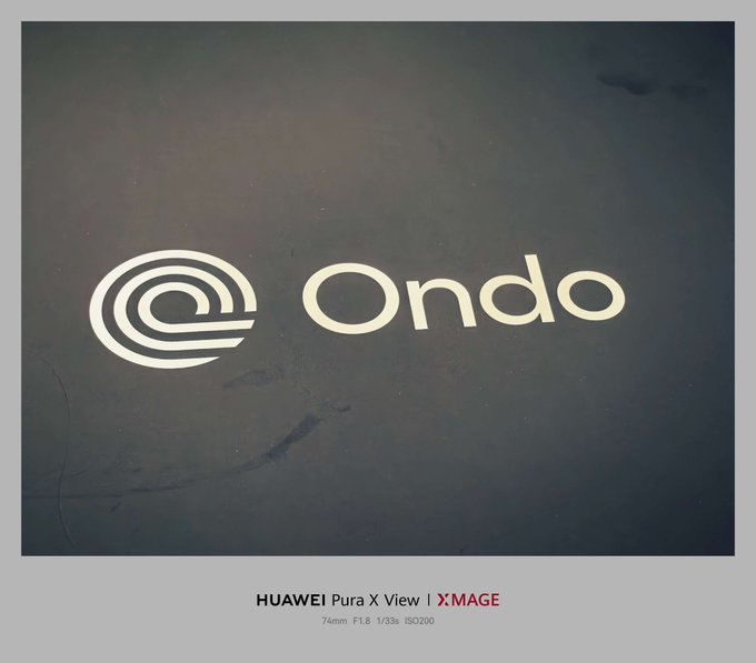 A dark photo showing the logo and name "Ondo" with a stylized '@' or spiral symbol, captured with a HUAWEI Pura X View | XMAGE camera at 74mm F1.8 1/33s ISO200.