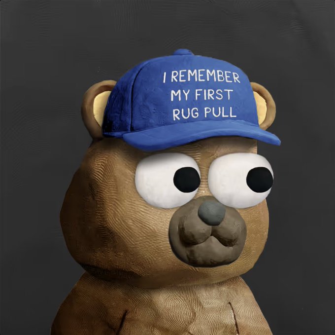 A brown teddy bear character with large, expressive eyes wears a blue baseball cap that reads "I REMEMBER MY FIRST RUG PULL," humorously acknowledging the NFT community's playful joke about the project's timing and the disappointment some felt waiting for the reveal, while the poster emphasizes their long-term commitment beyond the mint.