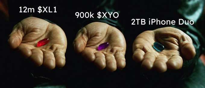 A reference to The Matrix film showing three hands offering pills labeled "12m $XL1" (red), "900k $XYO" (purple), and "2TB iPhone Duo" (blue).