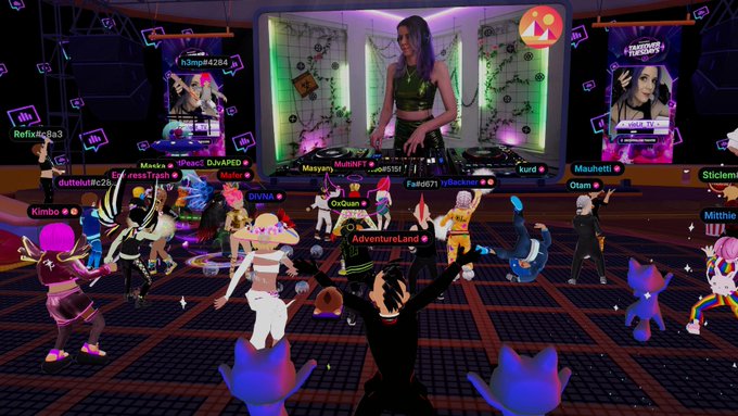 The image features a group of people dancing, with one person wearing a black dress standing out among them. They are all dressed up for a party or event, possibly at a club or dance floor. The background includes a TV screen displaying a video game character, and there is also a banner that reads "it is LIT".