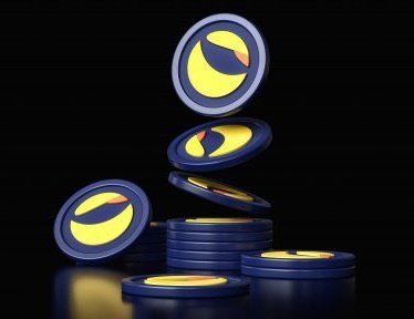 A 3D render of several blue and yellow crypto-style coins stacked and floating against a black background.