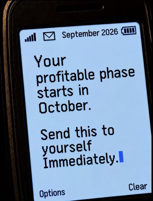 A phone screen displaying a SMS message dated 'September 2026' that reads: 'Your profitable phase starts in October. Send this to yourself Immediately.'