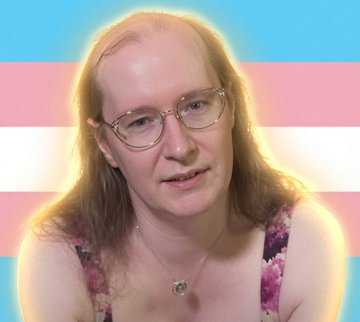 The image features a woman with long hair wearing glasses, who appears to be a young adult. She is wearing a purple top that has white stripes across the chest area. The background of the image is blue and white striped, which creates an interesting visual effect when combined with the woman's appearance. There are also some text elements in the image, including "Zcash vs Monero" written on it. This suggests that there might be a discussion or comparison between two different cryptocurrencies, such as Bitcoin (Zcash) and another cryptocurrency like Monero.