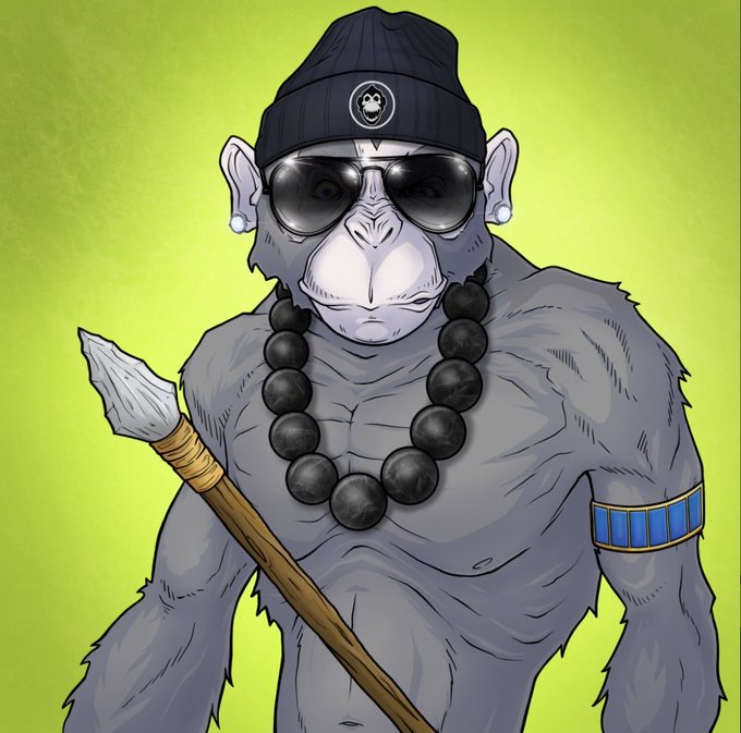 A stylized illustration of a muscular monkey wearing a black beanie with a small logo, sunglasses, a large beaded necklace, and a blue and gold armband, holding a wooden staff against a green background. The image reflects the "Welcome to the Grapes OG" post, presenting a cool, confident mascot-style character that visually represents the brand's bold, hip identity.