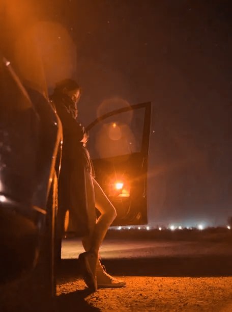 The image shows a person standing next to their car at night with an open door. The person appears to be looking out of the car, possibly contemplating or observing something happening outside. The surrounding area seems dark, which adds to the atmosphere of the scene. The photo is captioned "Gn Quack champ Fren tonight could be a very important one. Not because of the hype, but because tonight might show who is truly serious about @wallchain Before anything else, tell me this: How serious are you about Quack? I already know the real builders will show up." The focus on the person and their car suggests that they may have just arrived at a location or are preparing to leave.