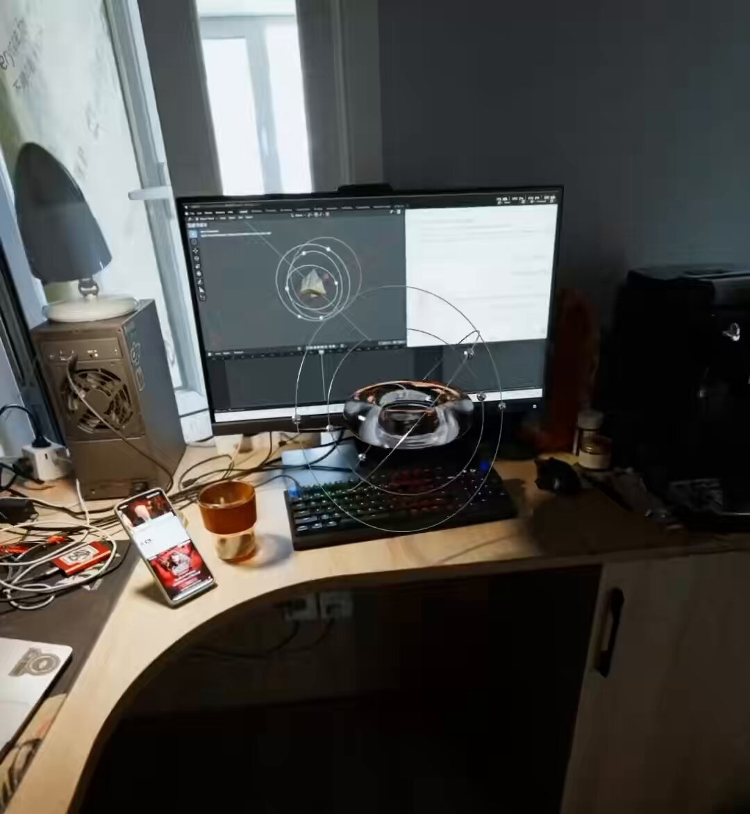 The image shows a computer desk with various items, including a monitor displaying a spiral design, a keyboard, a mouse, a cup of coffee, and several other objects such as a phone, a book, and a candle. The desk appears cluttered, suggesting that someone has been working or spending time at the space. In the background, there is a window with blinds, which could provide natural light for the workspace. The image also contains text that reads "I gotta hop on the Codex bus...damn". This phrase might be related to the spiral design displayed on the monitor, possibly indicating an ongoing project or task involving the Codex bus.