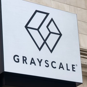 A sign for "GRAYSCALE" displays the company's geometric logo against a stone building facade. The image relates to the news of Grayscale withdrawing its ETF filings for Cardano (ADA), Hedera (HBAR), and Polkadot (DOT), highlighting the crypto asset manager's strategic pivot away from these altcoin products.