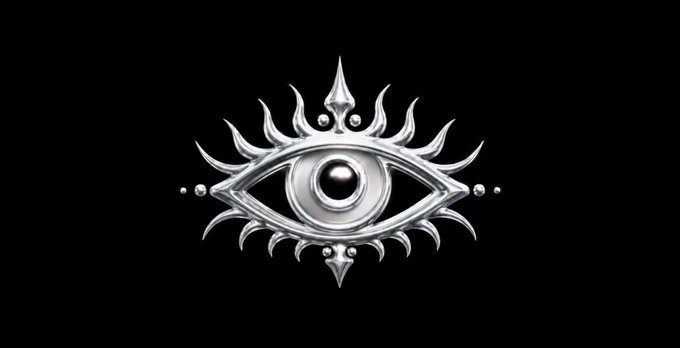 A silver metallic emblem featuring an eye with radiating decorative elements against a black background.