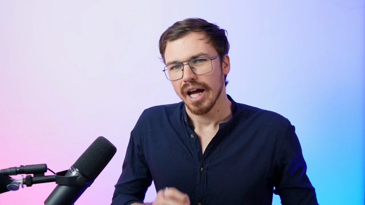 The image shows a man wearing glasses standing next to a microphone, likely at a podcast or speaking event. He appears to be making a speech or presentation about strategy. The background of the image is colored purple, which might suggest that he is talking about Bitcoin or technology in general. The caption below the photograph reads "Why Strategy $MSTR Has a Shot at being a $5T Company! ⇒ Fundamentals of Strategy are strong ⇒ Bitcoin Price is bound to recover ⇒ STRC is a killer accumulation machine". This caption might be related to the man's speech or presentation, as it seems to discuss strategy and its connection to technology.