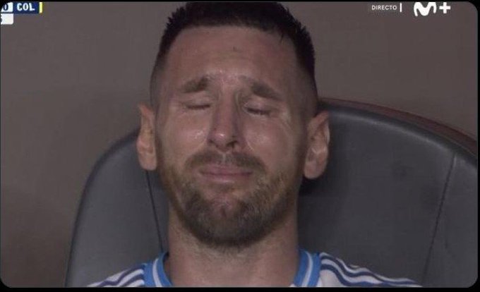 A screenshot from a sports broadcast (Movistar+) showing a male athlete in a blue jersey with his eyes closed, appearing emotional with visible tears on his face.
