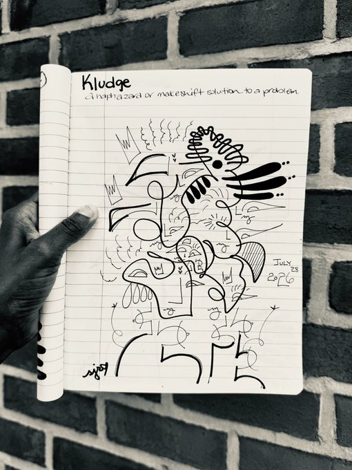 A hand holds up a notebook against a brick wall, displaying a page titled 'Kludge: a haphazard or makeshift solution to a problem' filled with abstract black marker drawings dated July 28.