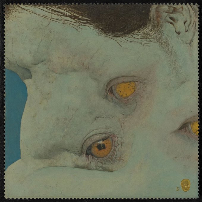 The image features a painting of a person's face with yellow eyes, which appears to be a portrait or a close-up of someone's face. The painting has a blue background that contrasts with the white face. The artist has used a unique color scheme for the eyes and nose, making them stand out against the rest of the image. The painting is framed by a black border, adding an artistic touch to the overall presentation.