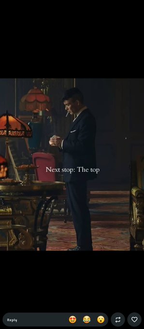 A man in a suit stands in an opulent, dimly lit room, smoking a cigarette while looking down at something in his hand. Text overlaid reads "Next stop: The top." The image complements the "gm builders" post about ambition and success, visually representing the confident mindset of those on the path to financial achievement.