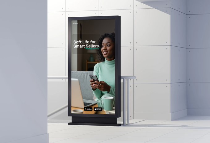 A digital billboard advertisement in a modern white-tiled space displaying "Soft Life for Smart Sellers" featuring a smiling woman using a phone and laptop, branded with the Kivo logo.
