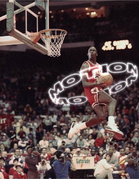 Michael Jordan in a red Chicago Bulls jersey is captured mid-air during a basketball slam dunk, with 'MOTION' text overlaid and a crowd visible in the background.