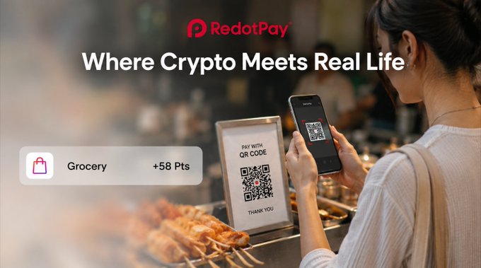 A RedotPay advertisement reads 'Where Crypto Meets Real Life' and shows a woman scanning a QR code with her phone at a bakery counter, with a 'Grocery +58 Pts' badge displayed.