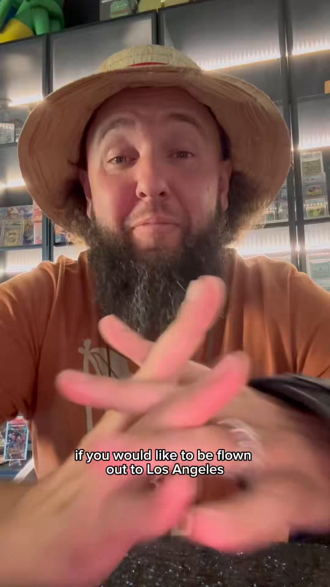 The image features a man wearing a hat, sitting at a table with his hands crossed over each other. The caption of the image reads "Let us fly you to LA for our launch event and card show this weekend with Collector Crypt and Solana!". This suggests that there is an upcoming event or product release related to cryptocurrency in Los Angeles.
