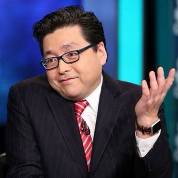 Tom Lee gestures while speaking in a studio setting. The post cites his bullish prediction that $ETH will rise above $10,000 within a year; no identifying text or figures are visible in the image.